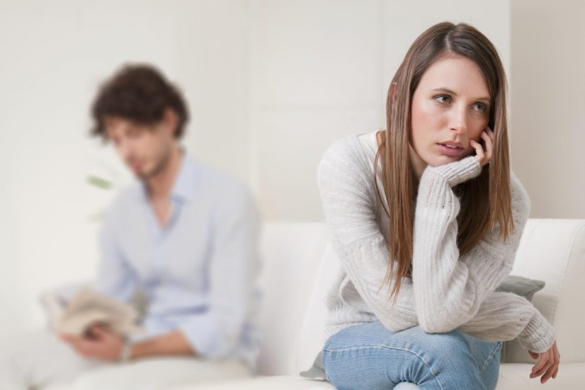 upset couple in lounge sad about lagging libido