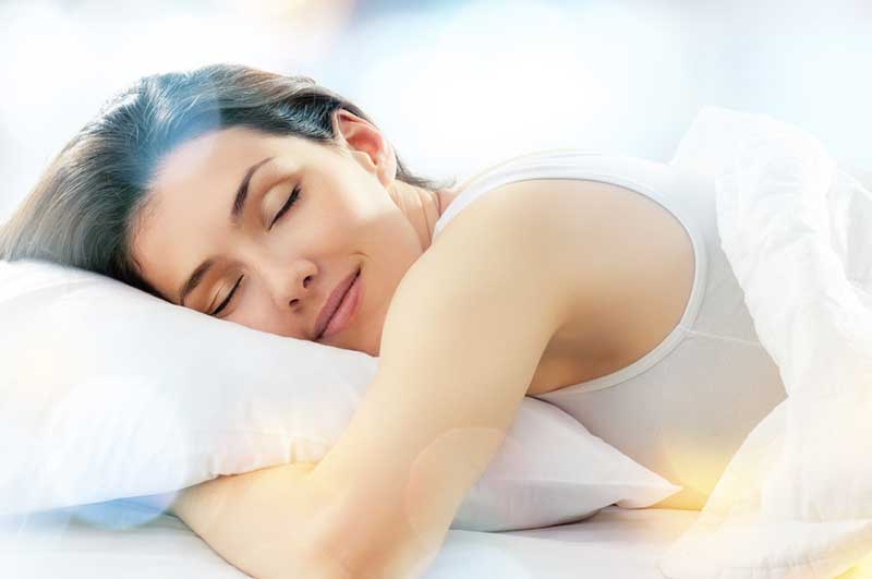 Woman Sleeping in Bed Photo
