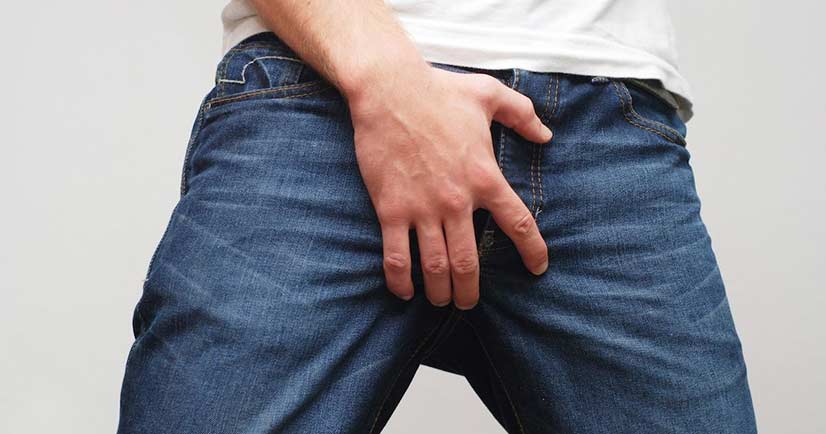 Man In Blue Jeans Holding His Crotch