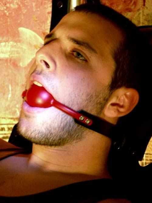 Naked Man Using BDSM Ball Gag In Mouth