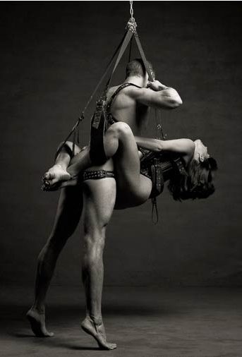 Couple using a sex swing