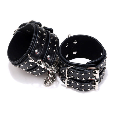 Studded Wrist Cuffs With Chain - Rabbit Vibrators