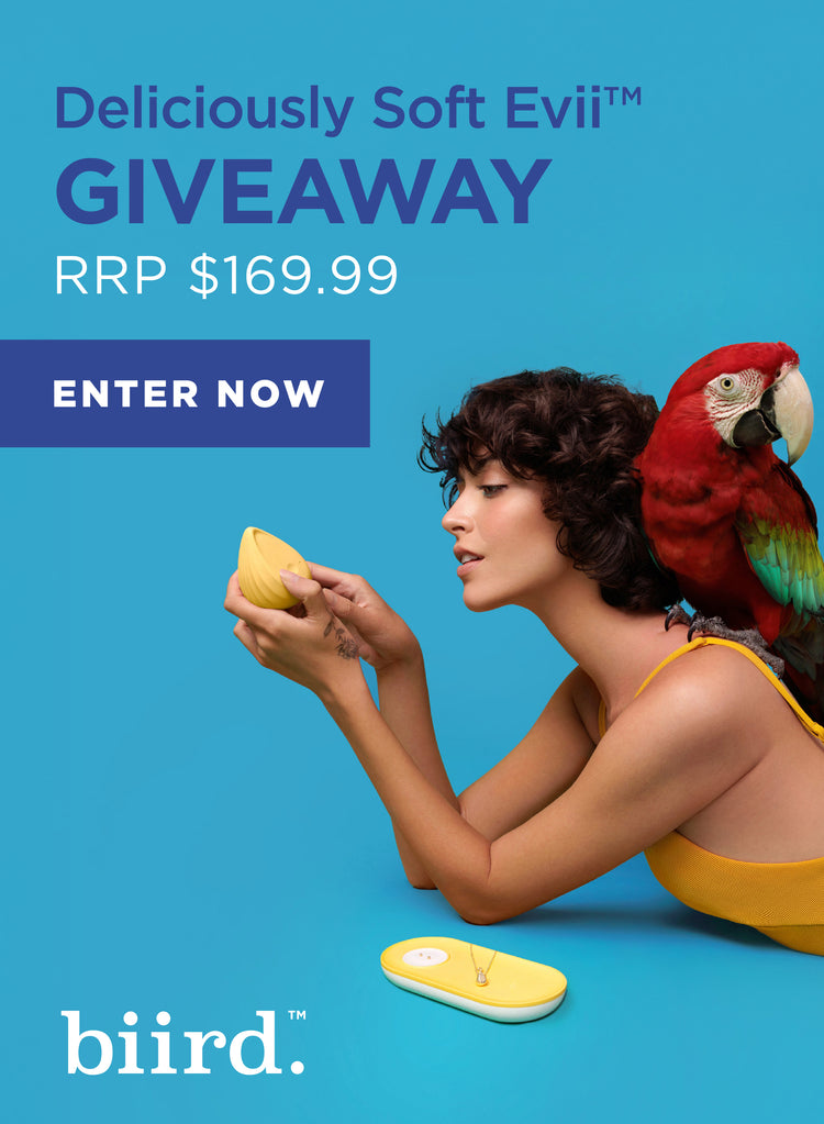 Promotional image for 'Deliciously Soft Evii' with a woman and parrot on a blue background, featuring text about a giveaway.