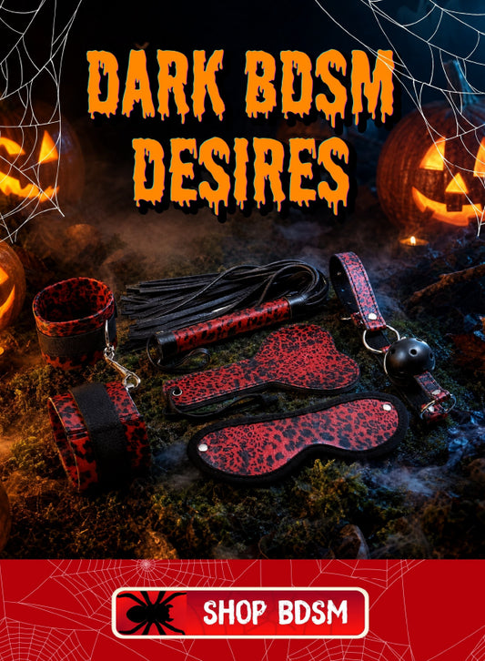 A Halloween-themed promotional graphic for dark BDSM accessories, featuring a set of red and black leopard-print cuffs, straps, paddle, and flogger laid out on mossy ground with jack-o'-lanterns and spiderwebs. Large orange text reads 'DARK BDSM DESIRES' and a red banner at the bottom says 'SHOP BDSM'.