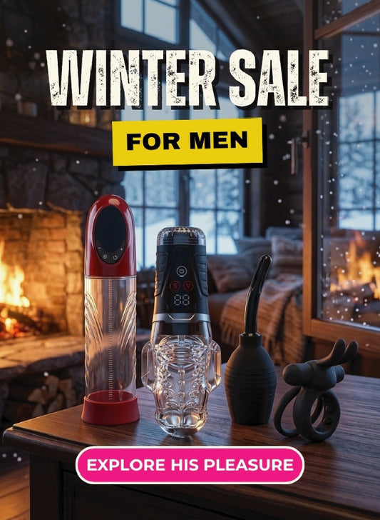 A promotional winter sale graphic for men showing several adult novelty products on a wooden table in front of a cozy fireplace and window scene. Large text reads 'WINTER SALE FOR MEN' and a pink badge at the bottom says 'EXPLORE HIS PLEASURE'.